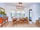 Cozy dining room with natural lighting, a wooden table, and stylish decor at 111 Alafia Estates Ln, Plant City, FL 33567