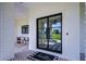 Elegant double doors with black frames and brick flooring, a welcome mat saying hello, and charming porch decor at 111 Alafia Estates Ln, Plant City, FL 33567