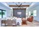 A modern living room with a large wall-mounted television, exposed beams and wood-look tile floors at 111 Alafia Estates Ln, Plant City, FL 33567