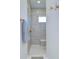 Modern bathroom with a glass enclosed shower, gray tiled walls, and gold accents at 111 Alafia Estates Ln, Plant City, FL 33567
