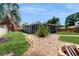 Backyard of home featuring lawn, brick path, and screened-in patio at 1202 E Caracas St, Tampa, FL 33603