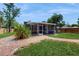 Backyard with lawn, brick path and screened in patio at 1202 E Caracas St, Tampa, FL 33603