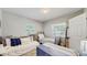Comfortable bedroom featuring twin beds, a cozy daybed, and a bright window offering a relaxing space at 1202 E Caracas St, Tampa, FL 33603