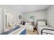 Comfortable bedroom featuring twin beds, a cozy daybed, and a bright window offering a relaxing space at 1202 E Caracas St, Tampa, FL 33603