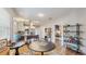 Bright dining area that is open to the kitchen and features hardwood floors, a round table, and modern decor at 1202 E Caracas St, Tampa, FL 33603