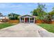 Charming home with a red door, front porch, and well-manicured lawn at 1202 E Caracas St, Tampa, FL 33603