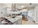 Modern kitchen with stainless steel appliances, white cabinets, granite countertops, and a sleek island at 1202 E Caracas St, Tampa, FL 33603