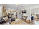 Spacious living room showcasing an open floor plan with hardwood floors and seamless flow to the dining area and kitchen at 1202 E Caracas St, Tampa, FL 33603