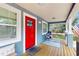 Cozy front porch with seating area and American flag at 1202 E Caracas St, Tampa, FL 33603