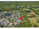 Serene aerial view of a home with a pool, nestled amidst lush greenery and tranquil lakes in a peaceful neighborhood at 14817 Tudor Chase Dr, Tampa, FL 33626