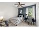 Stylish bedroom featuring a bed, a desk, and a chair by the window at 14817 Tudor Chase Dr, Tampa, FL 33626