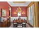Dining room features decorative wallpaper, a chandelier, and a large table for elegant dinners at 14817 Tudor Chase Dr, Tampa, FL 33626