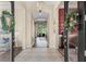 Inviting foyer with tile flooring, a view of the living space, and decorative wreaths on the double entry doors at 14817 Tudor Chase Dr, Tampa, FL 33626