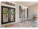 Attractive front entrance with double doors, decorative wreaths, and seating arrangements with potted flowers at 14817 Tudor Chase Dr, Tampa, FL 33626