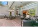 Beautiful lanai featuring outdoor dining and seating with views of the lush backyard and pool at 14817 Tudor Chase Dr, Tampa, FL 33626