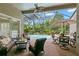 Relaxing lanai with comfortable seating, dining area, and a view of the sparkling pool at 14817 Tudor Chase Dr, Tampa, FL 33626