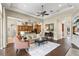 Open-concept living room features hardwood floors, modern ceiling fan, and seamless transition to kitchen at 14817 Tudor Chase Dr, Tampa, FL 33626