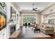Bright living room with fireplace, built-in shelves, and a large sliding glass door opening onto a patio at 14817 Tudor Chase Dr, Tampa, FL 33626