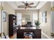 Office room features hardwood floors, a ceiling fan, windows with blinds, and built-in bookshelves at 14817 Tudor Chase Dr, Tampa, FL 33626