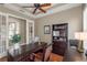 Well-lit office space with French doors, a ceiling fan, a large desk, and built-in bookshelves at 14817 Tudor Chase Dr, Tampa, FL 33626