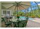 Inviting outdoor dining area with a clear view of the pool and lush landscaping at 14817 Tudor Chase Dr, Tampa, FL 33626