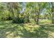 Lush greenery and mature trees provide a private and scenic backyard retreat with a tranquil view of the lake at 15810 Stanton Ln, Tampa, FL 33647