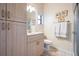 Well-lit bathroom with a vanity, tile flooring, and a shower with glass doors at 15810 Stanton Ln, Tampa, FL 33647