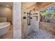 Stunning bathroom featuring a pebble floor shower and soaking tub at 15810 Stanton Ln, Tampa, FL 33647