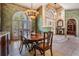 Elegant dining room features a chandelier, arched window, and doorway to the library at 15810 Stanton Ln, Tampa, FL 33647
