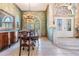 Elegant dining room with decorative walls, chandelier, and arched window at 15810 Stanton Ln, Tampa, FL 33647