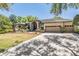 Stunning home features a three-car garage and beautifully landscaped front yard at 15810 Stanton Ln, Tampa, FL 33647