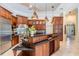 Gourmet kitchen featuring custom wood cabinets, stainless steel appliances, and a large island at 15810 Stanton Ln, Tampa, FL 33647