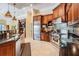 Spacious kitchen featuring custom wood cabinets, stainless steel appliances, and tile backsplash at 15810 Stanton Ln, Tampa, FL 33647