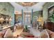 Elegant living area featuring detailed columns, a coffered ceiling mural, and an open layout for comfortable living at 15810 Stanton Ln, Tampa, FL 33647