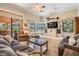 Bright, spacious living room with lots of light, a view of the lake, and comfortable seating at 15810 Stanton Ln, Tampa, FL 33647