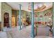 The exquisite living room showcases unique architectural columns, arched entryways, and a coffered ceiling mural at 15810 Stanton Ln, Tampa, FL 33647