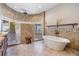 Luxurious bathroom featuring dual tiled showers and a freestanding soaking tub at 15810 Stanton Ln, Tampa, FL 33647