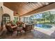 Inviting pool area with ample seating, screened enclosure and view of a lake at 15810 Stanton Ln, Tampa, FL 33647