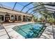 A stunning screened-in pool area with an outdoor lounge area perfect for entertaining on a sunny day at 15810 Stanton Ln, Tampa, FL 33647