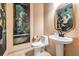 Charming powder room with painted mural and decorative mirror above the sink at 15810 Stanton Ln, Tampa, FL 33647