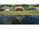Aerial view of a home with an orange exterior, screened-in lanai, and pond, ideal for relaxing outdoors at 1626 Brooksbend Dr, Wesley Chapel, FL 33543