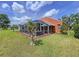 This backyard features a screened-in patio, manicured lawn, and an orange exterior, creating an ideal outdoor space at 1626 Brooksbend Dr, Wesley Chapel, FL 33543