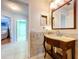 Bathroom vanity with decorative wood base, granite counter, and matching mirror at 1626 Brooksbend Dr, Wesley Chapel, FL 33543
