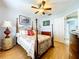 Bedroom with wood floors, four-poster bed, ceiling fan, and coordinated furnishings at 1626 Brooksbend Dr, Wesley Chapel, FL 33543