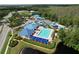 Aerial view of community pool, splash pad, waterslide, and basketball court with lush green landscaping at 1626 Brooksbend Dr, Wesley Chapel, FL 33543