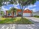 Charming single-story home with a well-manicured lawn, palm tree, and welcoming curb appeal at 1626 Brooksbend Dr, Wesley Chapel, FL 33543