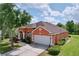 Charming exterior of a well-maintained, single-story home with a two-car garage and landscaped yard at 1626 Brooksbend Dr, Wesley Chapel, FL 33543