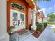 Inviting front entrance features decorative glass doors, a welcome sign, and manicured landscaping at 1626 Brooksbend Dr, Wesley Chapel, FL 33543