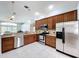 Kitchen with stainless steel appliances, wood cabinets, and ample counter space at 1626 Brooksbend Dr, Wesley Chapel, FL 33543