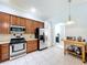Efficient kitchen with stainless steel appliances, tile backsplash, and wood cabinets at 1626 Brooksbend Dr, Wesley Chapel, FL 33543